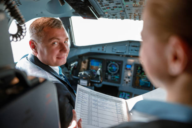 istock Aircraft pilot talking with stewardess in cockpit 1364780481
