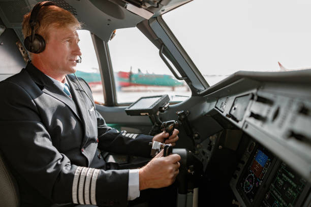 istock Male pilot in headphones controlling airplane flight 1364780507
