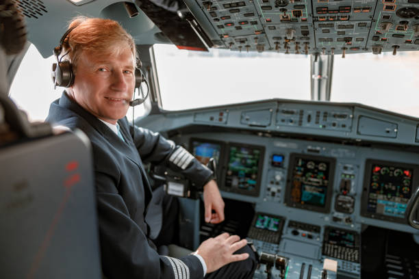 istock Joyful male pilot sitting in airplane cockpit 1364780513
