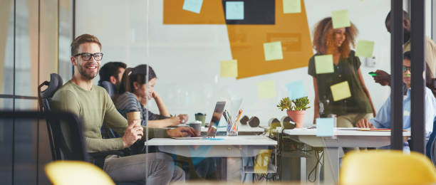 istock Young specialists working hard in a conference room 1364780653
