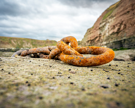 Rusty chain laid on rock