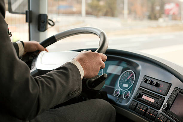 Close up of a bus driver going down the road stock photo