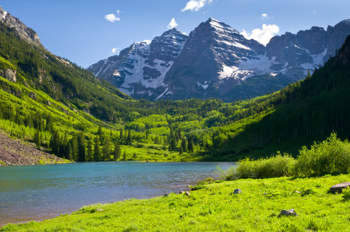 Maroon Bells in Summer Aspen Colorado.  Scenic view of North and South Maroon Peak with Maroon Lake.  Iconic Colorado location in national forest.  Captured as a 14-bit Raw file. Edited in ProPhoto RGB color space.