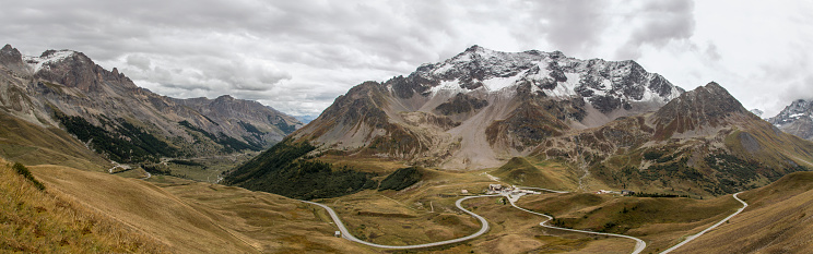 Col du Galibier, France - September 20, 2021: Panoramic view of the Col du Lautaret mountain pass in the French Alps with the Pic du Lac de Combeynot in the back