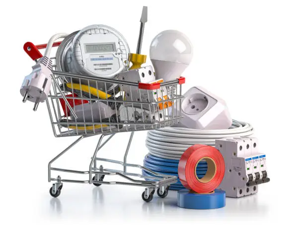 Photo of Shopping cart full of electrical components and equipment isolated on white.