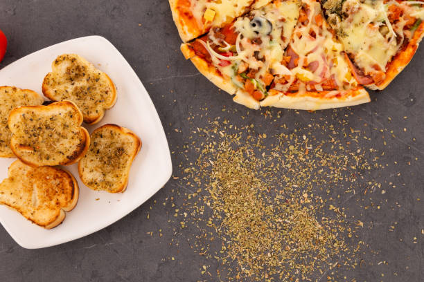istock garlic bread with oregano, sliced pizza with cheese, pineapple and ham, sprinkled with oregano, fast food, traditional 1364800812