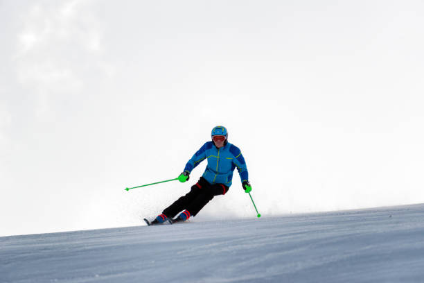 istock Skier skiing downhill on slope 1364800841