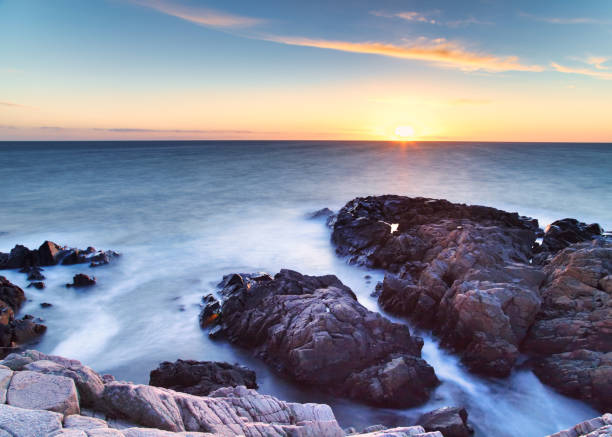 istock Sunset with rocks and sea 1364800857