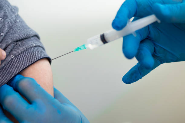 istock Injecting the coronavirus vaccine to a young man, antibodies, immunize population. side effects, risk people, antibodies, new normal, covid-19. 1364800899