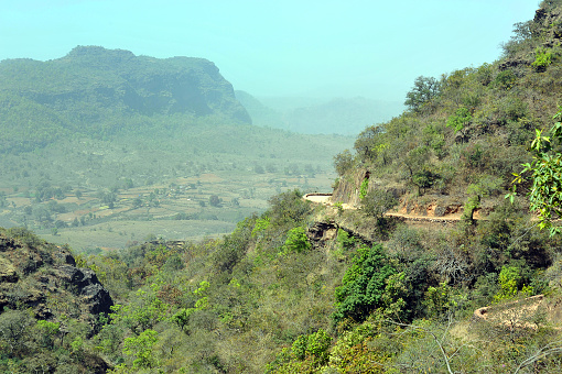 Road to Rorighat village, Satpura National Park, Madhya Pradesh, India. Wilderness areas such as Satpura are prime habitat for wild animals but difficult for tribal people who live in the jungle, where access can be cut off completely in the monsoons when dirt tracks or roads as seen here on this mountain side can be washed away