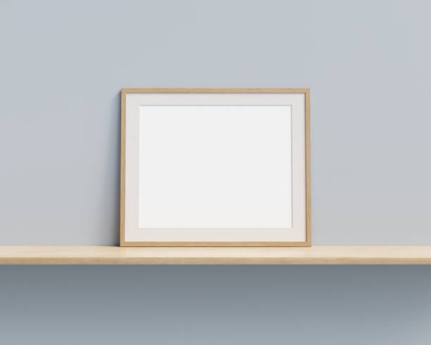 istock Picture frame mock up on wooden shelf against pastel painted wall. 3D render. 1364802692