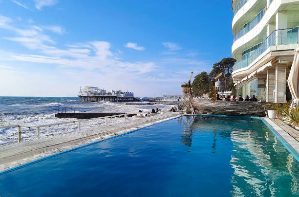 Beautiful building with a swimming pool on the beach in Sochi, Russia. Russia, Sochi. Sochi, Russia"u2013 January 09, 2022: Beautiful building with a swimming pool on the beach in Sochi, Russia. Russia, Sochi. sochi stock pictures, royalty-free photos & images