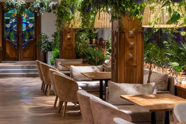 istock Modern classic restaurant interior with big glass windows and green live plants. 1364811746