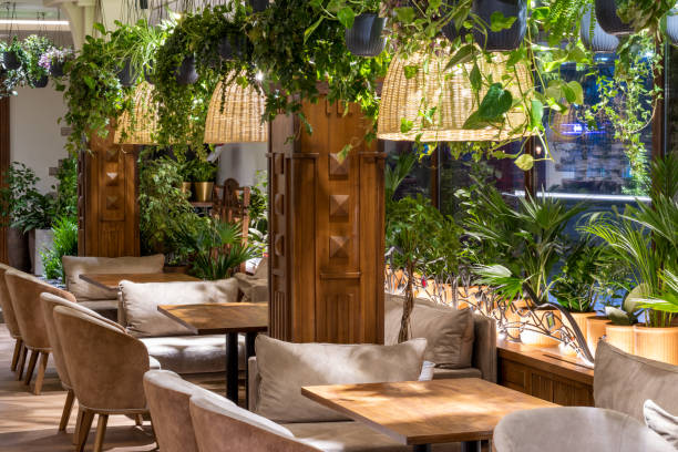 istock Modern classic restaurant interior with big glass windows and green live plants. 1364811811