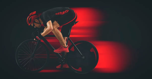 istock Man racing cyclist on black background. Matte image 1364813654