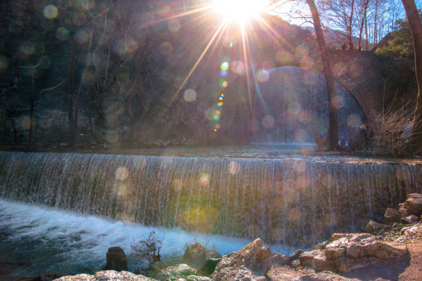 Paleokarya, old, stone, arched bridge, between two waterfalls. Trikala prefecture, Thessaly, Greece