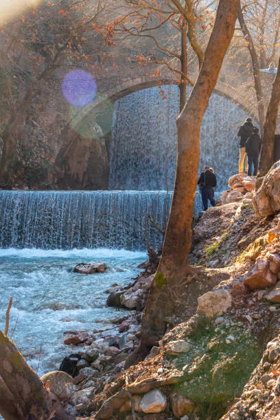 Paleokarya, old, stone, arched bridge, between two waterfalls. Trikala prefecture, Thessaly, Greece