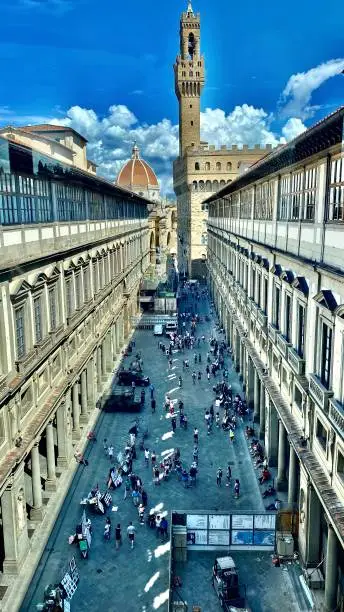 Photo of lofted view of the piazzale degli uffizi and the 
florentine artist's renderings of the marble renaissance statues before them.