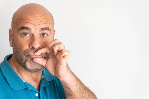 istock man pinches his lips with his fingers 1364818624