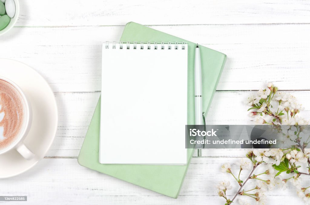 Creative flat lay of workspace desk, notepad on wooden background Creative flat lay of workspace desk, notepad for wishlist and lifestyle objects on wooden background Note Pad Stock Photo