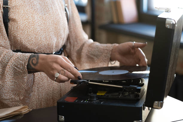 istock Woman listening the old record 1364824097