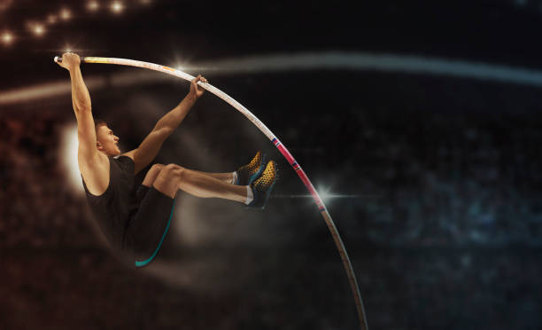 Professional pole vaulter training at the stadium in the evening. Sports banner. stock photo
