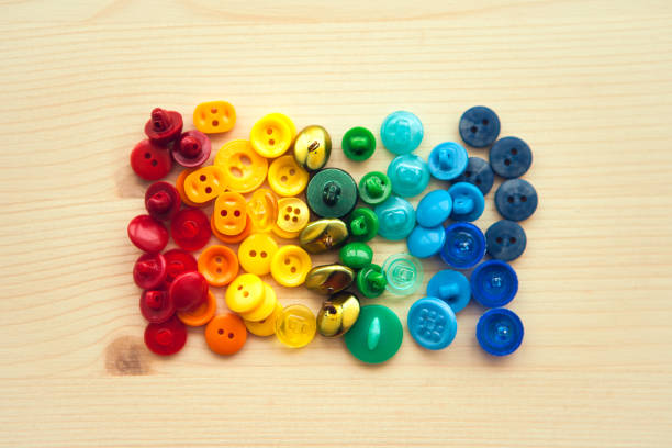 Multicolored buttons. Color rainbow buttons on wooden background.