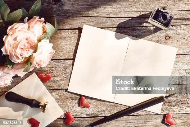 Valentine Day Theme Top View Of Love Letter Ink And Fountain Pen Roses And Envelope On Vintage Wooden Table Space For Text Stock Photo - Download Image Now
