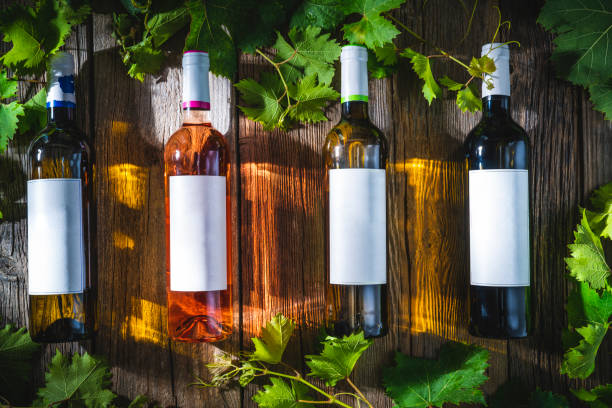 istock Four wine bottles assorted wines white rose and red wine on rustic wood 1364827732