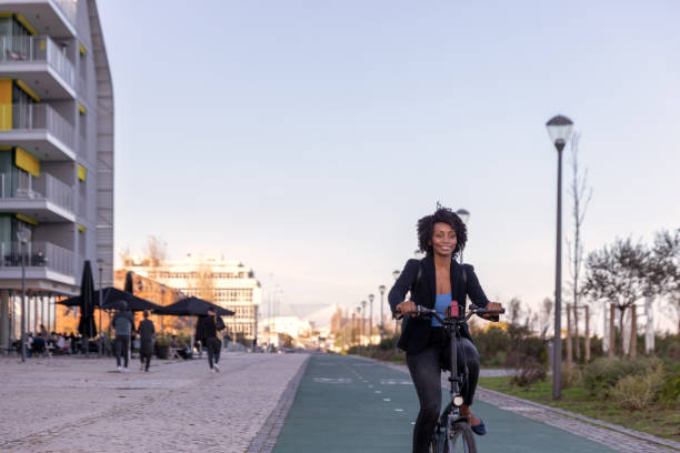 istock Young Black woman commuting in her bike 1364827770