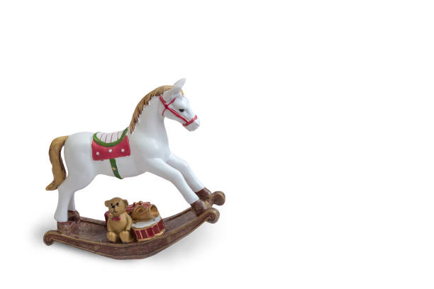 A wooden, antique rocking horse in a garden.