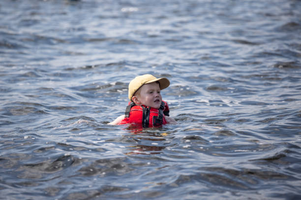 istock Young Boy Swimming in the Lake during Summer 1364827943