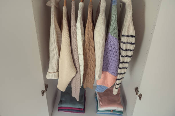 istock Woolen knit sweaters stacked and hanged in wardrobe 1364829895