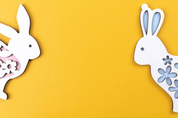 istock Easter rabbits on a yellow background, celebration border composition, flat lay, copy space and top view photo 1364830399
