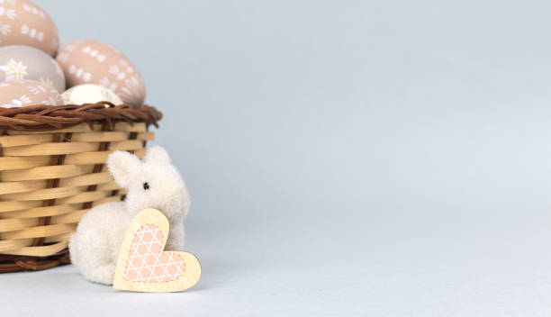 istock Easter bunny with basket full of easter eggs. Spring holiday concept, copy space photo 1364830517