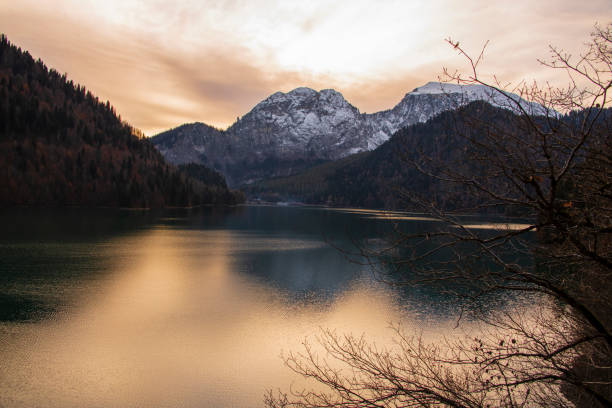 istock Landscape background - sunset over a mountain lake. 1364831620