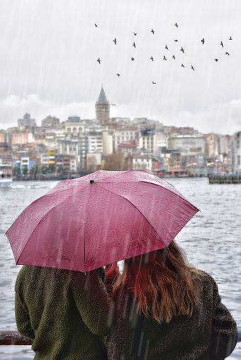 istanbul , Galata tower,  rainy day,  umbrella and birds