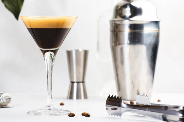 istock Espresso martini alcoholic cocktail with vodka, coffee liqueur, syrup and ice, white background, bar tools, copy space 1364834450