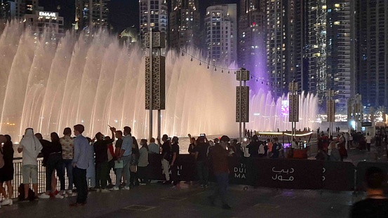 Dubai In United Arab Emirates Middle East, Building Exterior, People Standing, Walking, Talking To One Another, Taking Picture, Watching Dubai Mall Music And Light Fountain Show In The Evening Scene