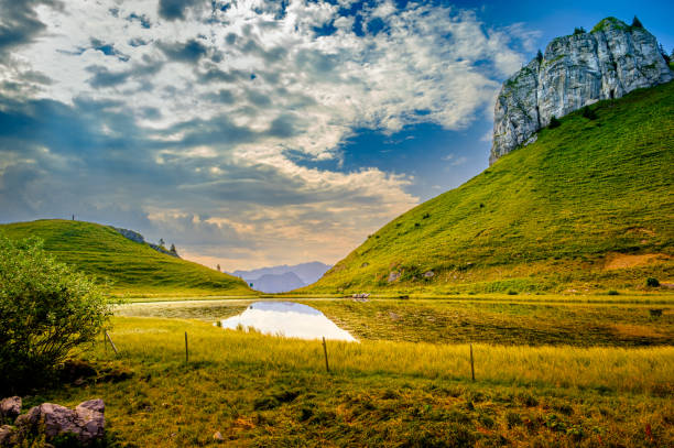 Stunning view on mountain lake Lac d'Ai in the Vaud Alps above Leysin on cloudy day in summer. Switzerland
