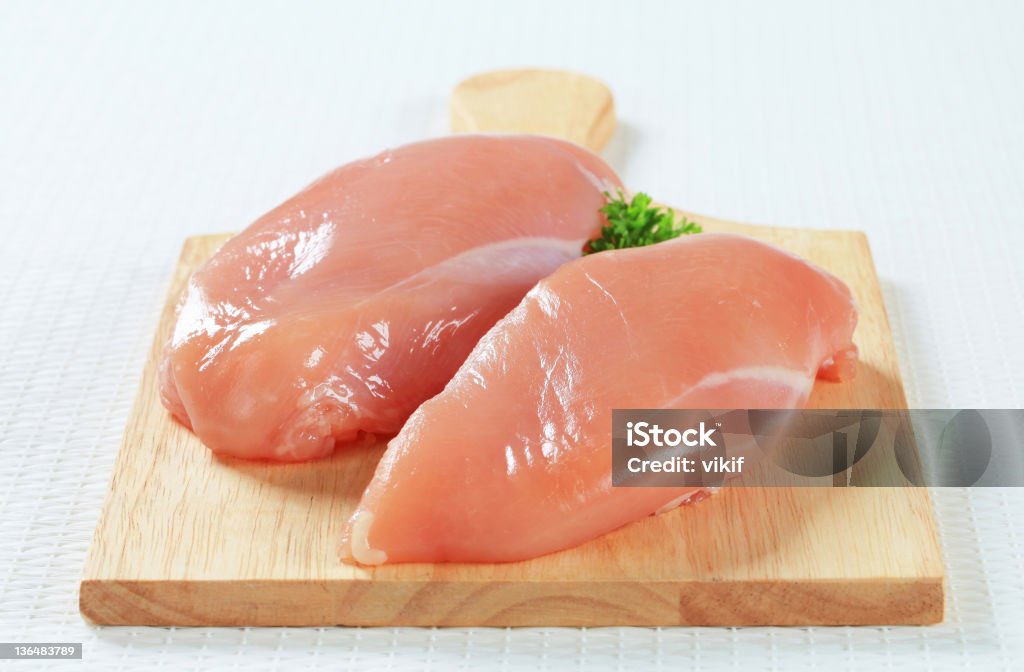 Fresh skinless chicken breast fillets Chicken Breast Stock Photo