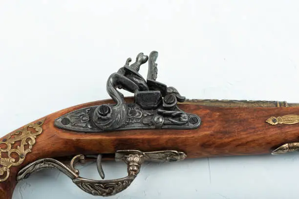 Close-up of the percussion lock of an antique single-shot pistol. Copy space.