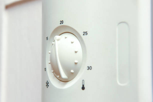 istock Thermostat to control central heating radiators in home is turned down to save costs on fuel bills 1364838044