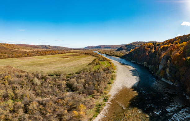 istock River rapids with autumn forests on banks under blue sky 1364838866