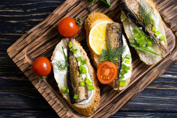 istock sprats in a can, fresh dill on wooden background 1364840671
