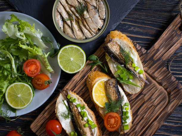 istock sprats in a can, fresh dill on wooden background 1364840805