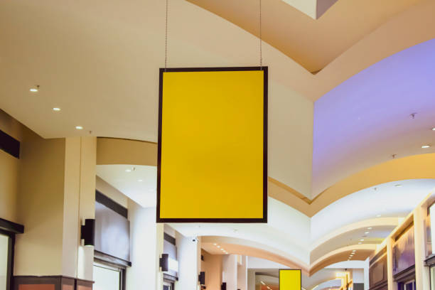 istock billboard inside the mall. Empty board filled with yellow color 1364844000