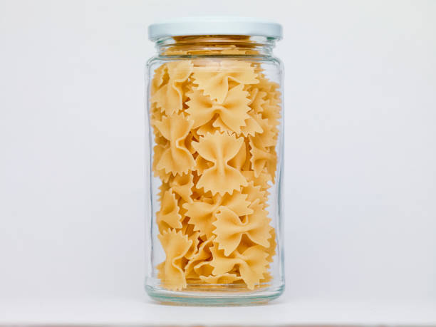 istock Pasta in glass jar on a white background 1364846278