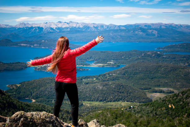 woman on top of a mountain with outstretched arms - south america argentina bariloche autumn imagens e fotografias de stock