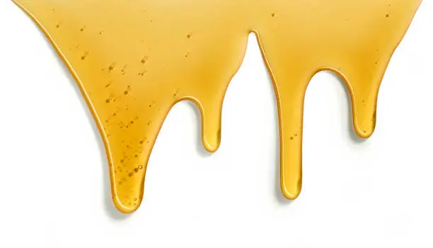 Photo of flowing honey on white background
